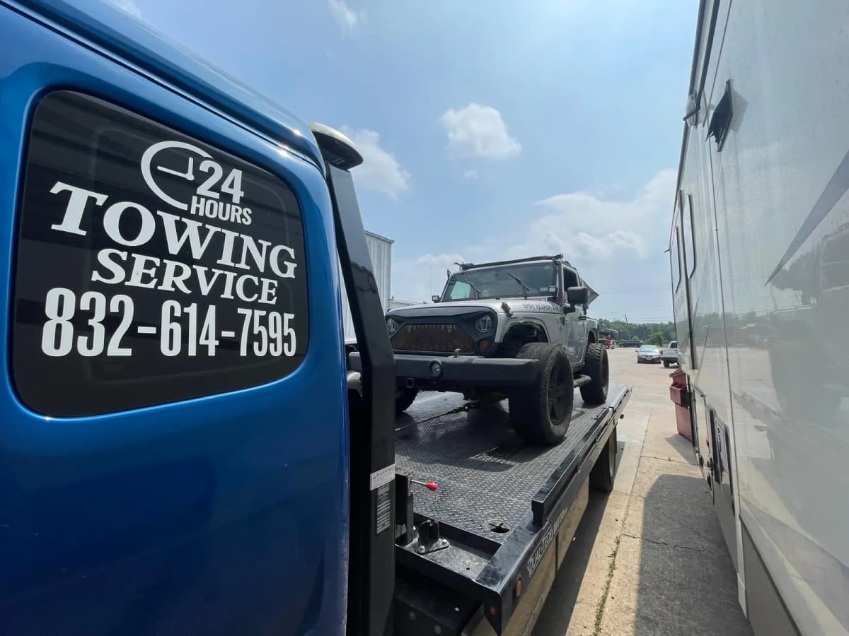 Jeep Wrangler on flatbed tow truck in Houston TX