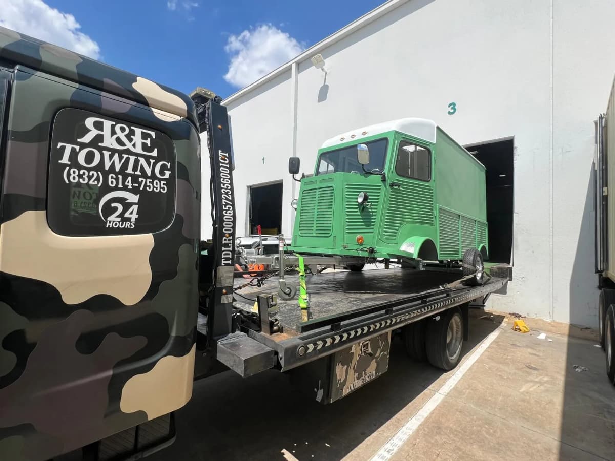 Classic Vehicle Towing - Vintage Van Houston TX Green vintage Citroen van on flatbed tow truck for classic vehicle transport in Houston TX