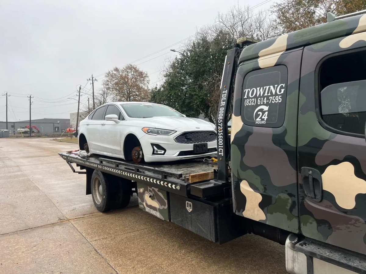 Vehicle Transport to a Partner Repair Shop - Houston TX Ford Fusion loaded on a Prime Towing LLC flatbed for transport to a partner repair shop in Houston TX