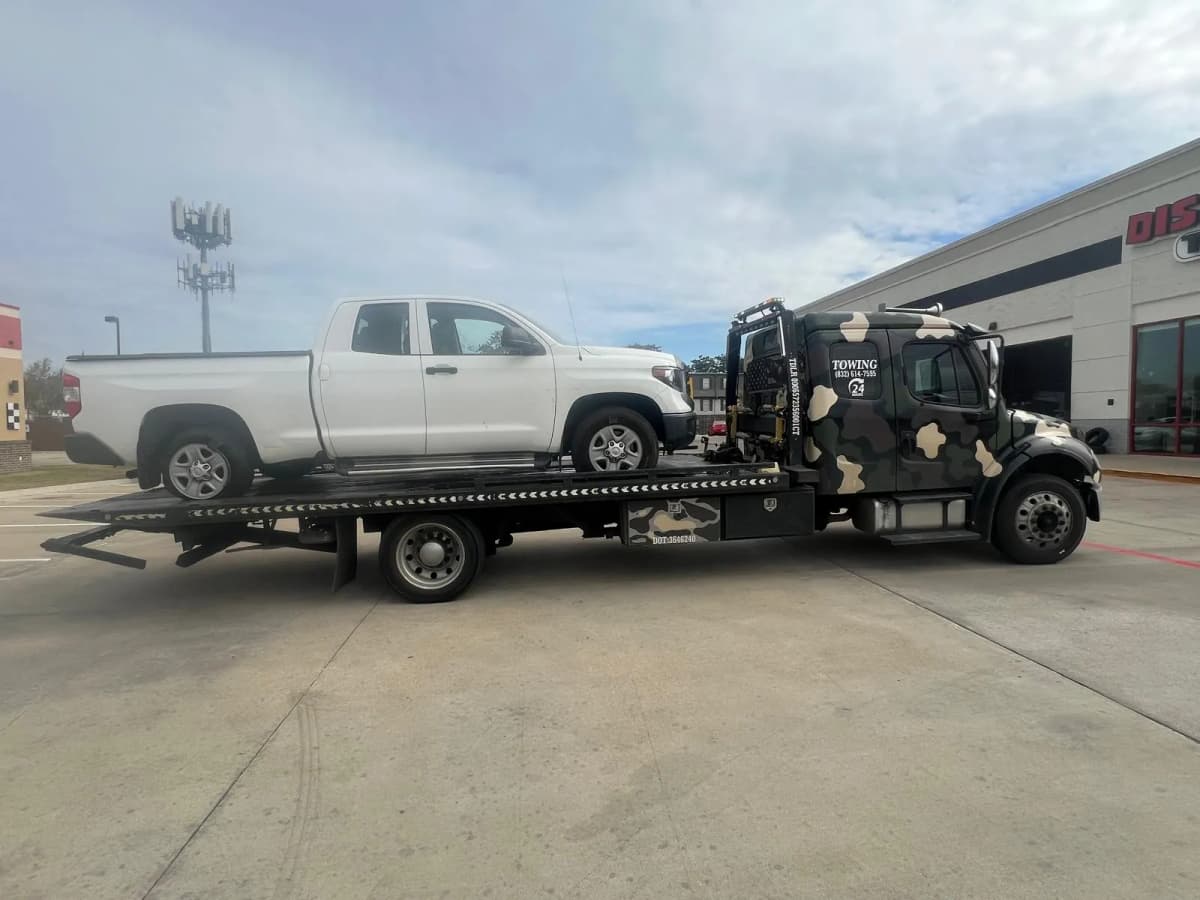 Toyota Tacoma Towing - Houston TX White Toyota Tacoma pickup on flatbed tow truck in Houston TX