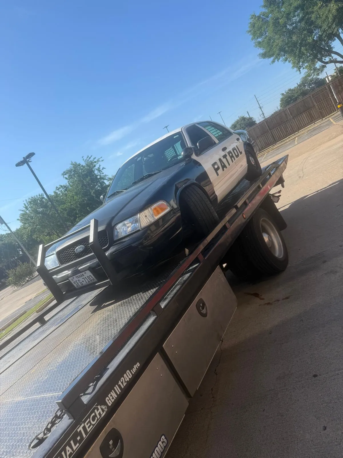 Patrol vehicle on flatbed tow truck in Houston TX