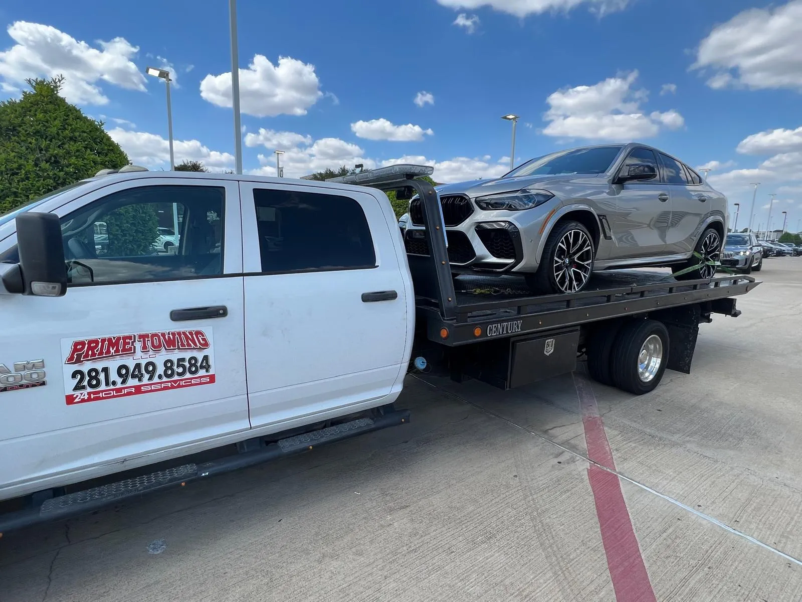 Prime Towing LLC white truck towing BMW X6M on flatbed in Houston TX