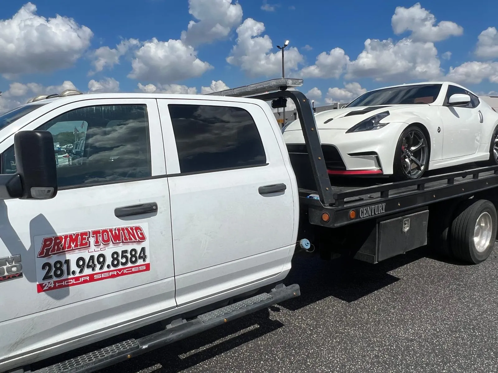 Prime Towing LLC towing white Nissan 370Z sports car on flatbed in Houston TX